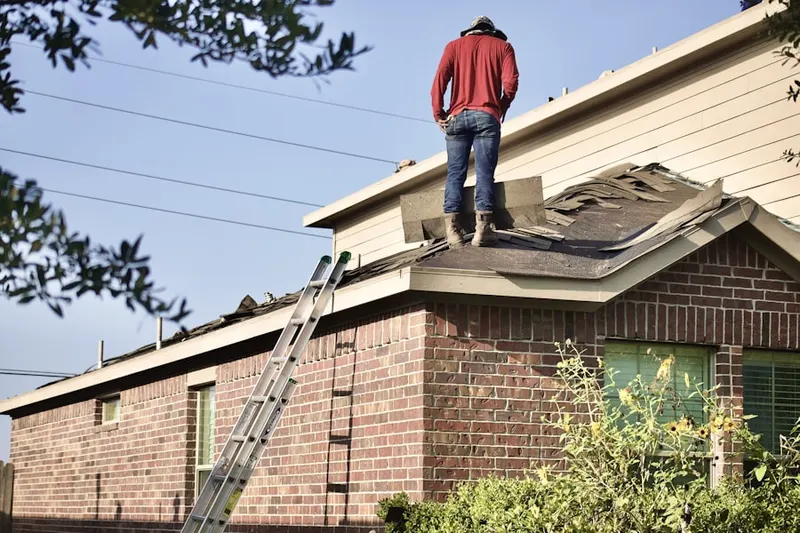 Professional roofer working on a residential roof in Van Syckles